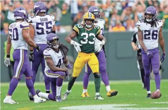  ?? DAN POWERS / USA TODAY NETWORK-WISCONSIN ?? Aaron Jones (33) and his fellow Green Bay running backs had a big impact on Minnesota’s defense Sunday.