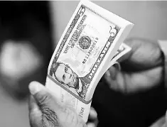  ?? — Reuters photo ?? A packet of former US President Abraham Lincoln five-dollar bill currency is inspected at the Bureau of Engraving and Printing in Washington.