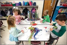  ?? NWA Democrat-Gazette/SPENCER TIREY ?? Kindergart­ners Analie Dryer (From Left) Kendall Langley, Kathryn Cooksey and Blake Harris work on making jingle bell necklace in Cristine Eubanks’ class at Thomas Jefferson Elementary in Bentonvill­e. This is the third year students have done the...