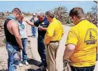  ?? [PHOTO PROVIDED] ?? Two victims of the May 20, 2013, Moore tornado are prayed over by Oklahoma Baptist Disaster Relief Director Sam Porter, Baptist General Convention of Oklahoma Executive Director-Treasurer Anthony Jordan and another convention official.