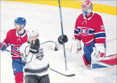  ?? CP PHOTO ?? Los Angeles Kings’ Adrian Kempe (9) celebrates his goal as Montreal Canadiens’ Paul Byron (41) and Canadiens goalie Carey Price (31) look on during first-period NHL hockey action Thursday night in Montreal.