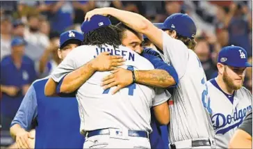  ?? Wally Skalij Los Angeles Times ?? KENLEY JANSEN is hugged by Matt Kemp after the Dodgers’ Game 4 victory in Atlanta, which advanced them into the NLCS against Milwaukee. Clayton Kershaw will start Friday’s series opener.