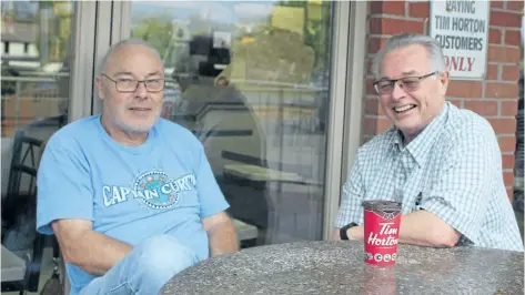  ?? ALLAN BENNER/STANDARD STAFF ?? Bill McAvoy and Ron Allen share a coffee at the Tim Hortons in Port Dalhousie, slated for closure at the end of the month.