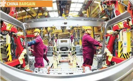  ?? — Reuters ?? Employees are seen working in an auto production line in Weifang, Shandong province, China.