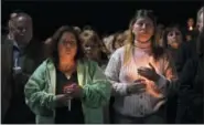  ?? HANS PENNINK — THE ASSOCIATED PRESS ?? Maria Busch, left, and Tammy Smith, both of Amsterdam, N.Y., gather with family and friends for a candleligh­t vigil memorial Monday at Mohawk Valley Gateway Overlook Pedestrian Bridge in Amsterdam, N.Y.