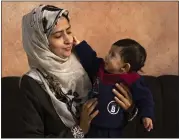  ?? FATIMA SHBAIR — THE ASSOCIATED PRESS ?? Amal Al-Taweel plays with her baby, Ali, at her family home in Zawaida, central Gaza Strip, on Friday. Ali was also born Oct. 7. Both of their homes were leveled by airstrikes.