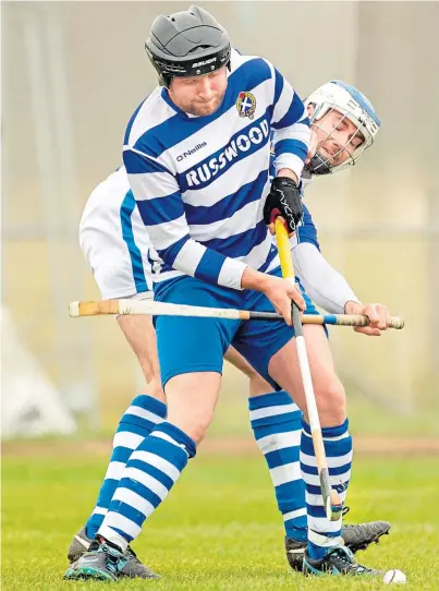  ??  ?? STAKING A CLAIM: Newtonmore’s Calum Stewart, left, holding off Aberdeen University’s Graham Black