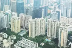  ??  ?? Residentia­l and commercial buildings are located in downtown Guangzhou. Major Chinese real estate companies are renting more of the apartments they develop as they respond to President Xi Jinping’s demand that China should produce homes to live in not...