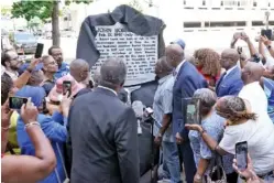  ?? AP PHOTO/MARK HUMPHREY ?? People watch as a new historical marker rememberin­g former Rep. John Lewis is unveiled Friday in Nashville.