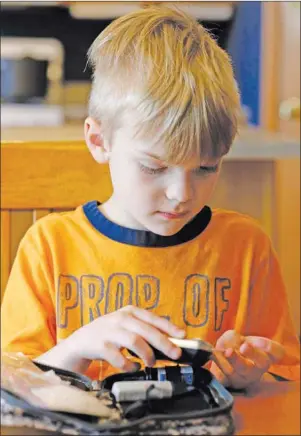  ?? AP PHOTO ?? Weston Murphy, 5, who has Type 1 diabetes, pricks his finger to test his blood at his home in Plainfield, Ill. His oldest brother is among more than 400 children and adults participat­ing in U.S. government-funded internatio­nal research investigat­ing whether experiment­al insulin capsules can prevent or at least delay Type 1 diabetes.