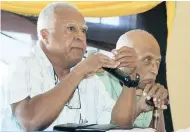  ??  ?? Coconut Industry Board director Granville Marsh (left) responds to a question from a member of the board during a recent meeting in Port Maria, St Mary, while a pensive Frank Phipps, QC (second left), pays keen attention.