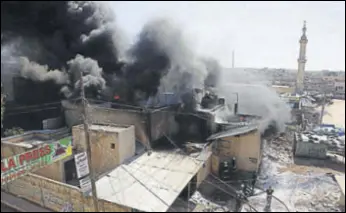  ?? AFP ?? Members of the Syrian Civil Defence try to put out a fire at the site of reported air strikes in the town of Khan Sheikhun in Idlib province in Syria.