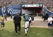  ?? LOS ANGELES TIMES FILE PHOTO ?? Carson Wentz walks off the field after suffering a season-ending injury Sunday in Los Angeles. Wentz suffered a torn ACL in his left knee.