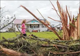  ?? GARY COSBY JR. / TUSCALOOSA NEWS ?? Sarah Sharpe helps the cleanup at Jimmy Doughty’s home in Pickens County, Ala., after a likely tornado struck Thursday. High winds damaged several homes in northwest Alabama. Minor injuries were reported.
