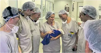  ?? Picture: SWNS ?? The Brazilian medical team with the baby born following the successful uterus transplant