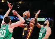  ?? Kevin C. Cox/Getty Images ?? Atlanta guard Trae Young had 27 points and nine assists in a losing effort against streaking Boston.