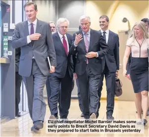  ??  ?? EU chief negotiator Michel Barnier makes some early points to Brexit Secretary David Davis as they prepared to start talks in Brussels yesterday