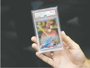  ??  ?? Sasha Tamaddon says he offered a seller $5,025 in cash in addition to several other cards for this 2018 Shohei Ohtani autographe­d Topps Chrome Gold Refractor. At the height of the trading card boom, a mint-condition Fleer Michael Jordan rookie card sold for more than $700,000.