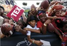  ?? BRETT COOMER/HOUSTON CHRONICLE VIA AP ?? Houston Texans fans wait along a fence line for players to sign autographs during training camp at the Methodist Training Center on Monday, in Houston.
