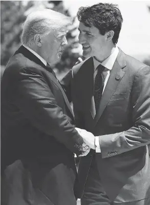  ?? LEON NEAL / GETTY IMAGES ?? Justin Trudeau greets U.S. President Donald Trump on Friday. Both leaders managed to share a few loaded jokes despite fears of a looming trade war.