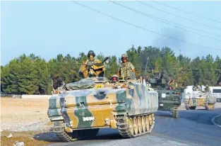  ?? — Reuters ?? OFFENSIVE: Turkish armoured personnel carriers drive towards the border in Karkamis on the Turkish-Syrian border in the southeaste­rn Gaziantep province, Turkey, on Saturday.