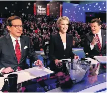  ?? Charlie Neibergall / AP ?? Panellists on TV news shows check their smartphone­s during the ad breaks to know what the viewers are thinking.