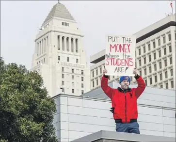  ?? Irfan Khan Los Angeles Times ?? A MAN holds a sign Jan. 15 in support of striking L.A. teachers. The labor standoff ended Tuesday, but it has intensifie­d conversati­ons in California and beyond about class sizes, charter schools, teachers’ wages and more.