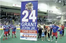  ?? CLIFFORD SKARSTEDT/EXAMINER FILES ?? A banner is raised to the rafters as Peterborou­gh Century 21 Lakers' John Grant Jr. with family members his wife, Raygen, daughter Gabrayel, father John, mother Louise, Raygenís mother Bonnie Rogers, John Jr.'s sisters Jaime-Lyn Grant and her family...