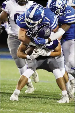  ?? RICK NATION/CONTRIBUTI­NG PHOTOGRAPH­ER ?? Bryant junior linebacker Jakob Neel, No. 37, tackles Fayettevil­le’s running back Jackson White during 2017 action. Neel is the 2017 Tri-Lakes Edition Defensive Player of the Year.