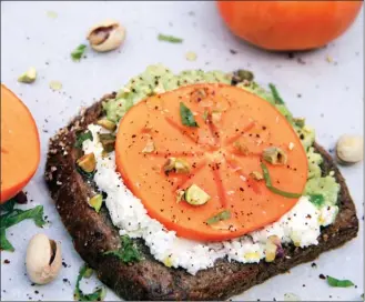  ?? The Associated Press ?? Avocado and goat cheese toast with persimmon is pictured in Bethesda, Md. (Melissa d'Arabian via AP)