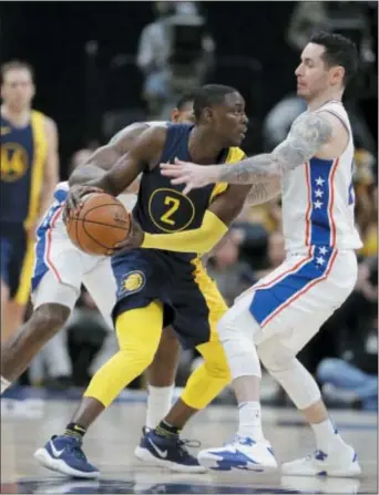  ?? DARRON CUMMINGS — THE ASSOCIATED PRESS ?? JJ Redick, right in this shot from a game against the Indiana Pacers and Darren Collison Saturday, clearly needs some help standing tall as the Sixers’ main bench helper on offense as the NBA trading deadline approaches.