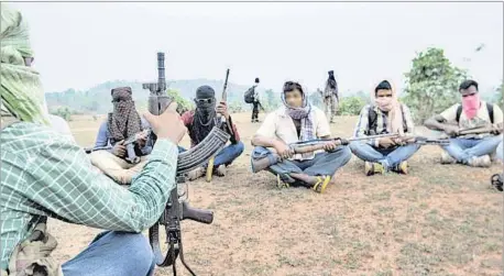  ??  ?? Armed PLFI men takes a breather while moving in the wooded hills along Jharkhand-Odisha border. PARWAZ KHAN/HT PHOTO