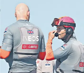  ??  ?? Mastermind­s: Ben Ainslie talks to team-mate Chris Brittle after Team Ineos defeated Luna Rossa in the Prada Cup last week