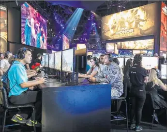  ?? Photograph­s by Irfan Khan Los Angeles Times ?? VIRTUAL REALITY gaming is still in its infancy. Above, E3 visitors at the L.A. Convention Center.