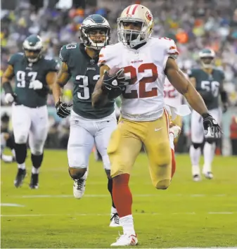  ?? Abbie Parr / Getty Images ?? Rookie running back Matt Breida speeds toward the end zone after catching a shovel pass. His 21-yard reception, one of his four catches, resulted in his first NFL touchdown.