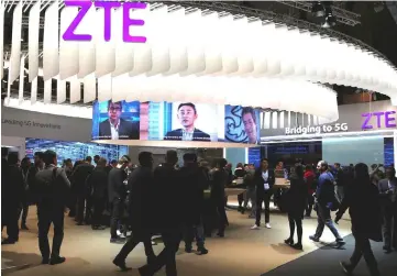  ??  ?? People stand at ZTE’s booth during Mobile World Congress in Barcelona, Spain, Feb 27, 2017. — Reuters photo