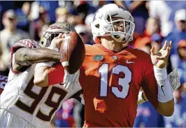  ?? JOHN RAOUX / AP ?? FSU defensive end Brian Burns (99) strips the ball from Florida quarterbac­k Feleipe Franks, one of two turnovers the Noles turned into touchdowns.