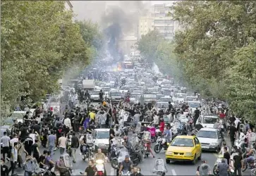  ?? Associated Press ?? PROTESTERS RALLY in downtown Tehran on Sept. 21 to decry the in-custody death of Mahsa Amini, 22. Activists at more recent demonstrat­ions have been beaten by the basij, a force of paramilita­ry volunteers.