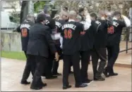  ?? LYNNE SLADKY — THE ASSOCIATED PRESS ?? Pallbearer­s wear a No. 16 jersey in honor of Miami Marlins pitcher Jose Fernandez as they carry his casket for a memorial service at St. Brendan’s Catholic Church, Thursday in Miami. Fernandez was killed in a boating accident Sunday along with two...