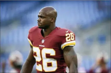  ?? NICK WASS — ASSOCIATED PRESS ?? Redskins running back Adrian Peterson warms up before Thursday’s preseason game against the Ravens in Baltimore.