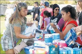  ??  ?? A NOVEMBER event at Wells Park offers food for the homeless. The City Council in October adopted an ordinance prohibitin­g such donations on city property.