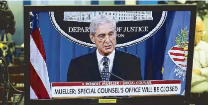  ?? REUTERS ?? Special counsel Robert Mueller is shown speaking on a monitor about his report into Russia’s role in the 2016 US election in the Briefing Room of the White House in Washington.