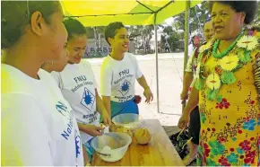  ??  ?? Students demonstrat­ing to Eci Nabalarua how Rotuman delicacy “taroro” is made.