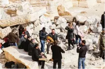  ??  ?? Syrian musicians play at the site of the damaged Roman amphitheat­er.