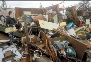  ?? AP/Miami Herald/PEDRO PORTAL ?? Haley Nelson stands in the wreckage of her family’s property Wednesday in Panama City, Fla., where Hurricane Michael caused extensive damage when it slammed ashore.