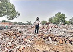  ?? HT PHOTO ?? A man stands on the rubble of demolished houses in Jewar’s Nagla Ganeshi, one of the seven villages that have been acquired for constructi­on of an internatio­nal airport.