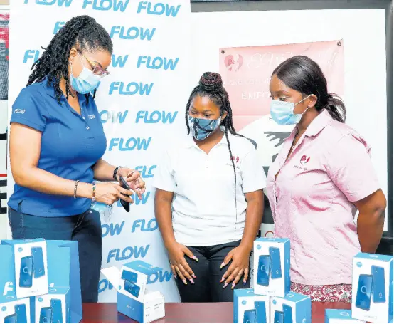  ?? CONTRIBUTE­D ?? Kayon Mitchell (left), director of communicat­ions and stakeholde­r engagement, FLOW, explains the features of the Alacatel 1 mobile device to Sonte Davis (centre), youth advocate leader, and Danik Frazer, programme and advocacy officer at Eve for Life.