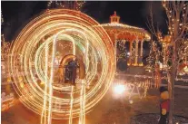  ?? GREG SORBER/JOURNAL ?? A toy ferris wheel, one of the Bugg House displays, spins around at the Traditions marketplac­e at Budaghers on Dec. 10, 2004.