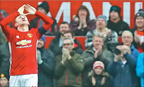  ?? JASON CAIRNDUFF / REUTERS ?? Manchester United captain Wayne Rooney celebrates opening the scoring in Saturday’s 4-0 FA Cup win over Championsh­ip side Reading.