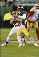  ?? CHRIS SZAGOLA — THE ASSOCIATED PRESS ?? 49ers running back Christian McCaffrey (23) is literally wrapped up by Eagles defensive end Robert Quinn during the NFC championsh­ip game (98) Jan. 29 at Lincoln Financial Field.
